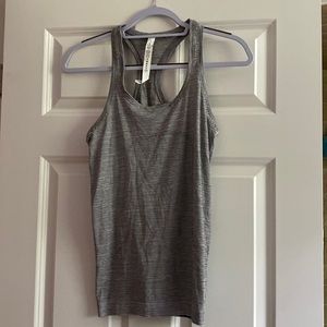 Lululemon tank gray and white stripe. Size 6. Perfect condition. Worn once.